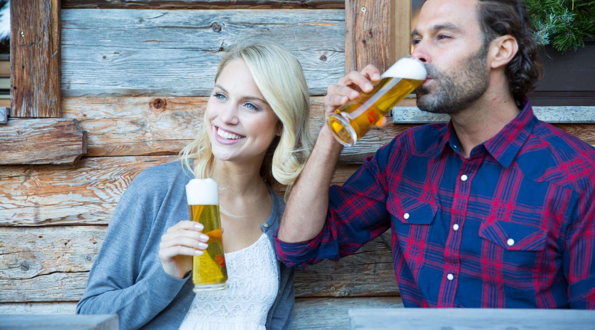 Junges Paar genießt Bier auf der Alm